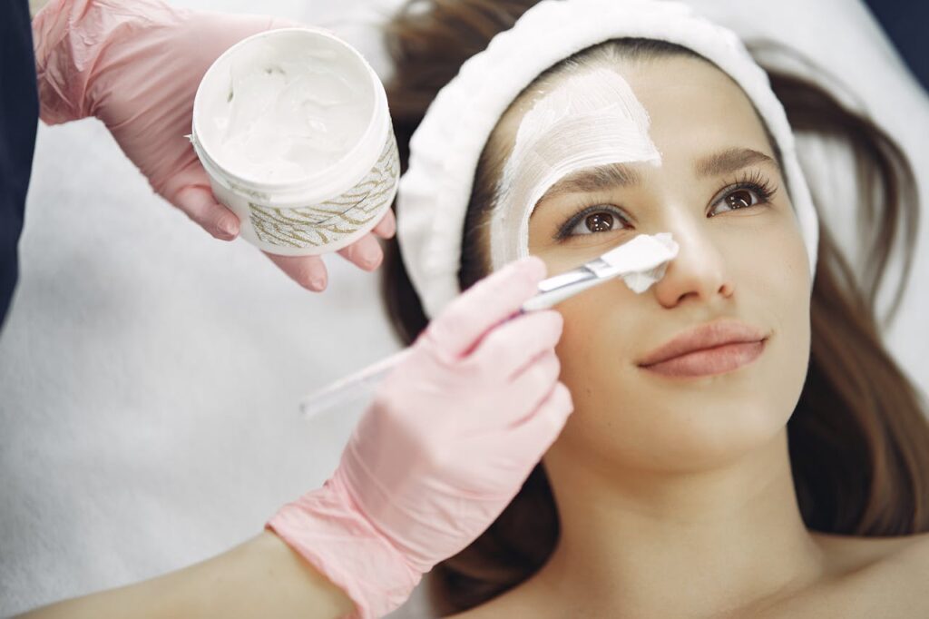 pexels photo 3985331 Close-up of a woman receiving a facial treatment at a spa with a cream mask applied using a brush.